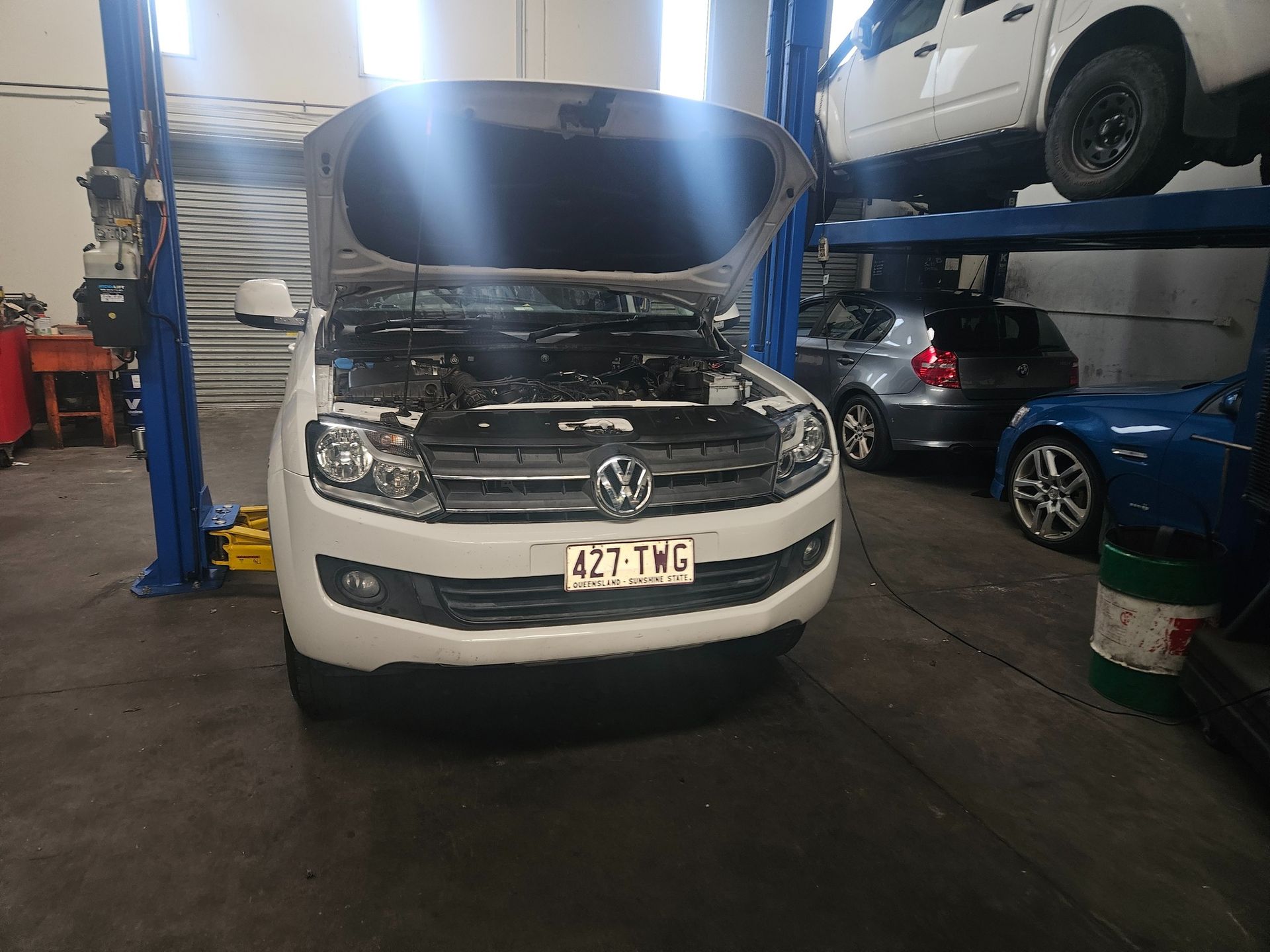 Mechanic in Blue Jumpsuit Using Diagnostic Tool on Car Engine — R&B Automotive PTY LTD In Urangan, QLD