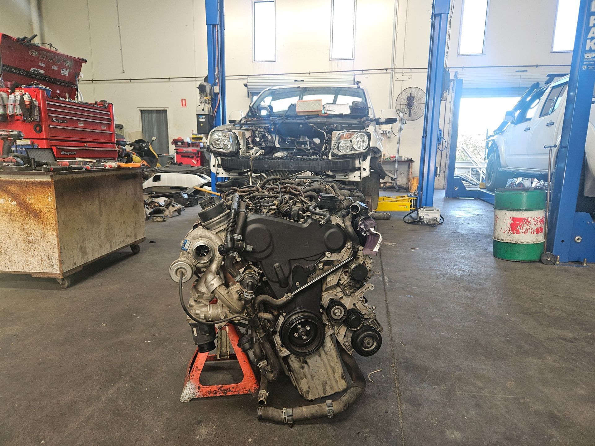 Engine on a Stand in a Garage, With a Partially Disassembled Car — R&B Automotive PTY LTD In Burrum Heads, QLD