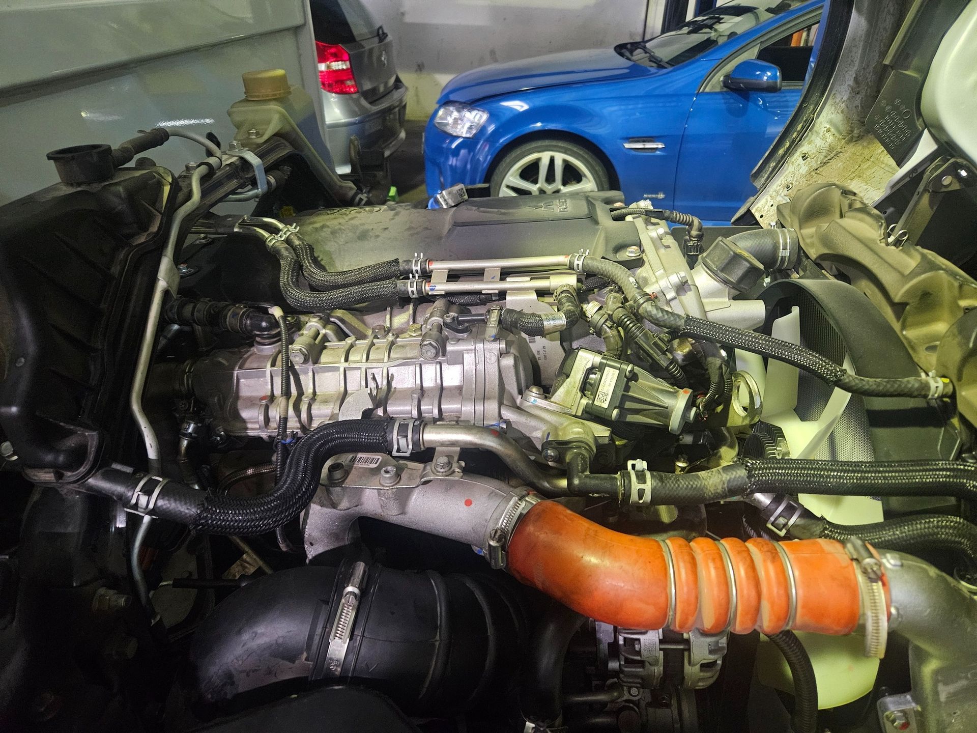 Mechanic Checking Engine Oil With Dipstick, Wiping It With a Cloth in a Car Engine Bay — R&B Automotive PTY LTD In Urangan, QLD