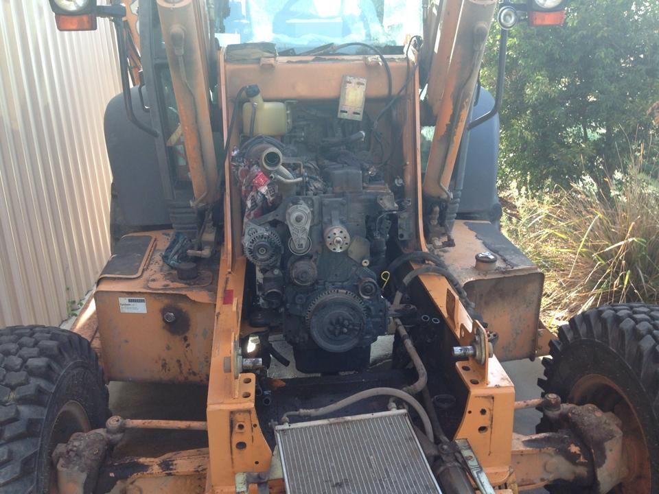 Backhoe With Engine Exposed, Likely Under Repair — R&B Automotive PTY LTD In Urangan, QLD