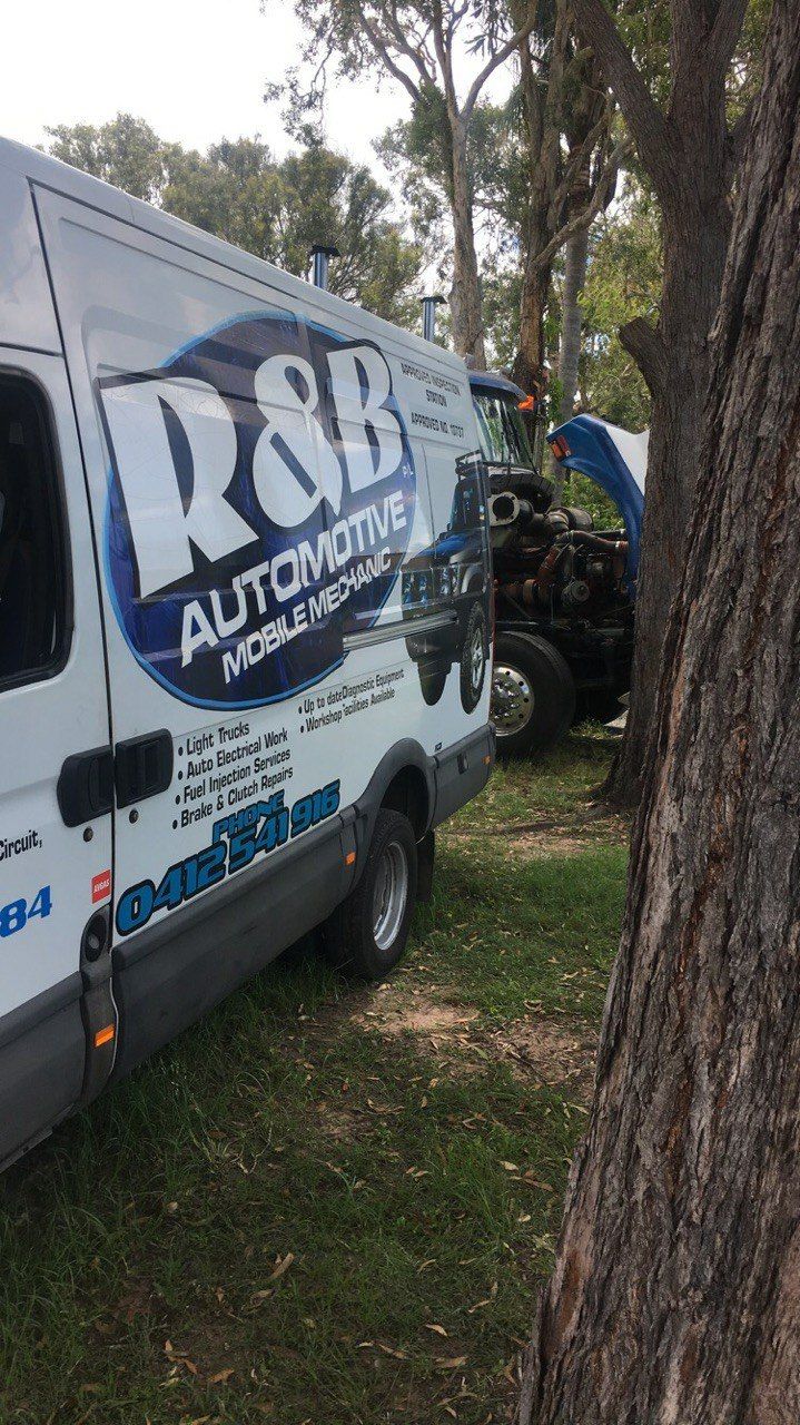 Van Parked Near a Truck With an Open Hood Outdoors — R&B Automotive PTY LTD In Urangan, QLD