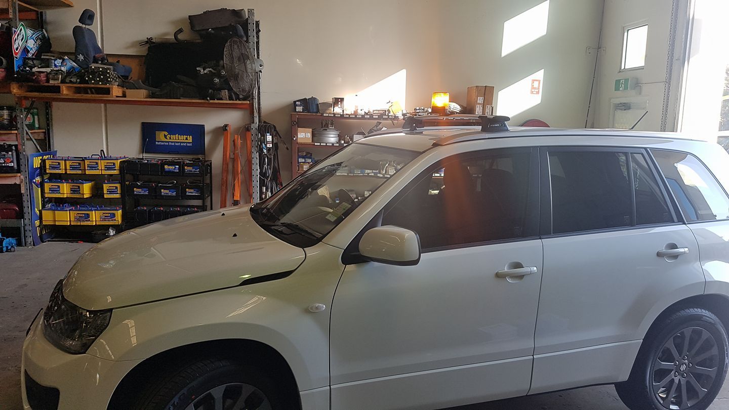 White SUV Parked Inside a Garage, Sunlight Shining in — R&B Automotive PTY LTD In Urangan, QLD