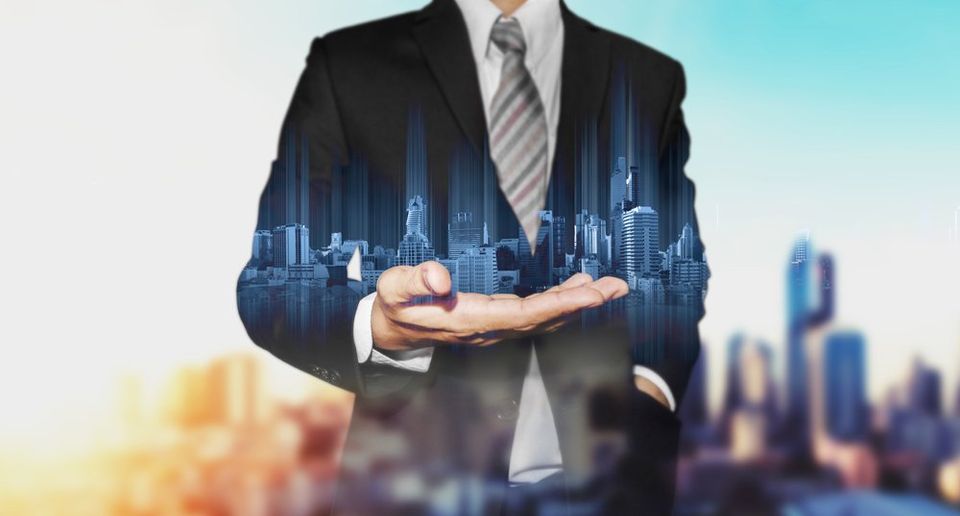 Double exposure businessman holding blue city hologram