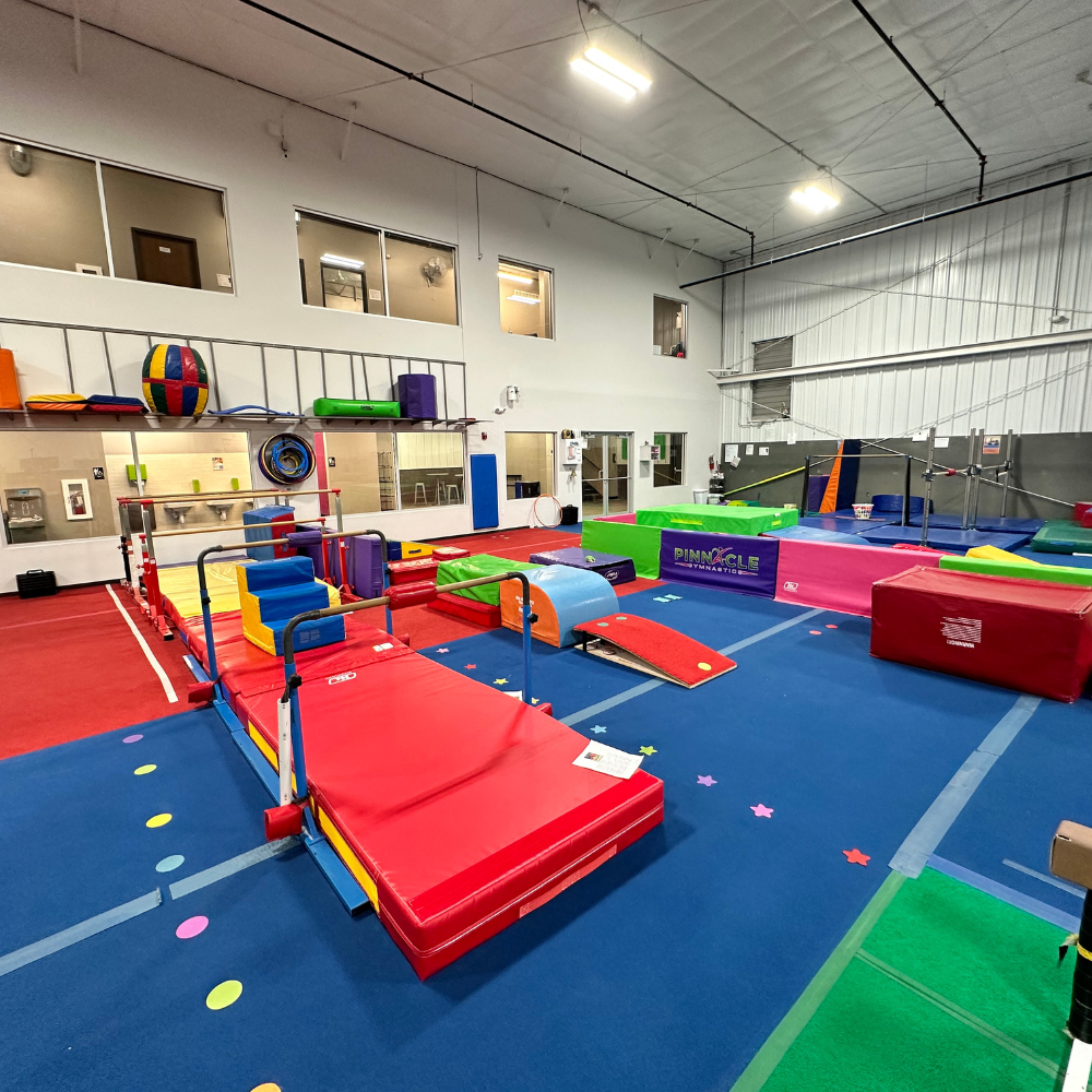 A gymnastics studio filled with a variety of exercise equipment