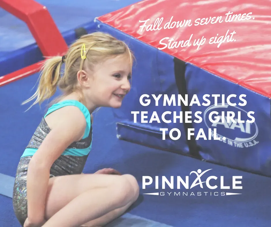 A little girl on the floor getting ready to stand back up.