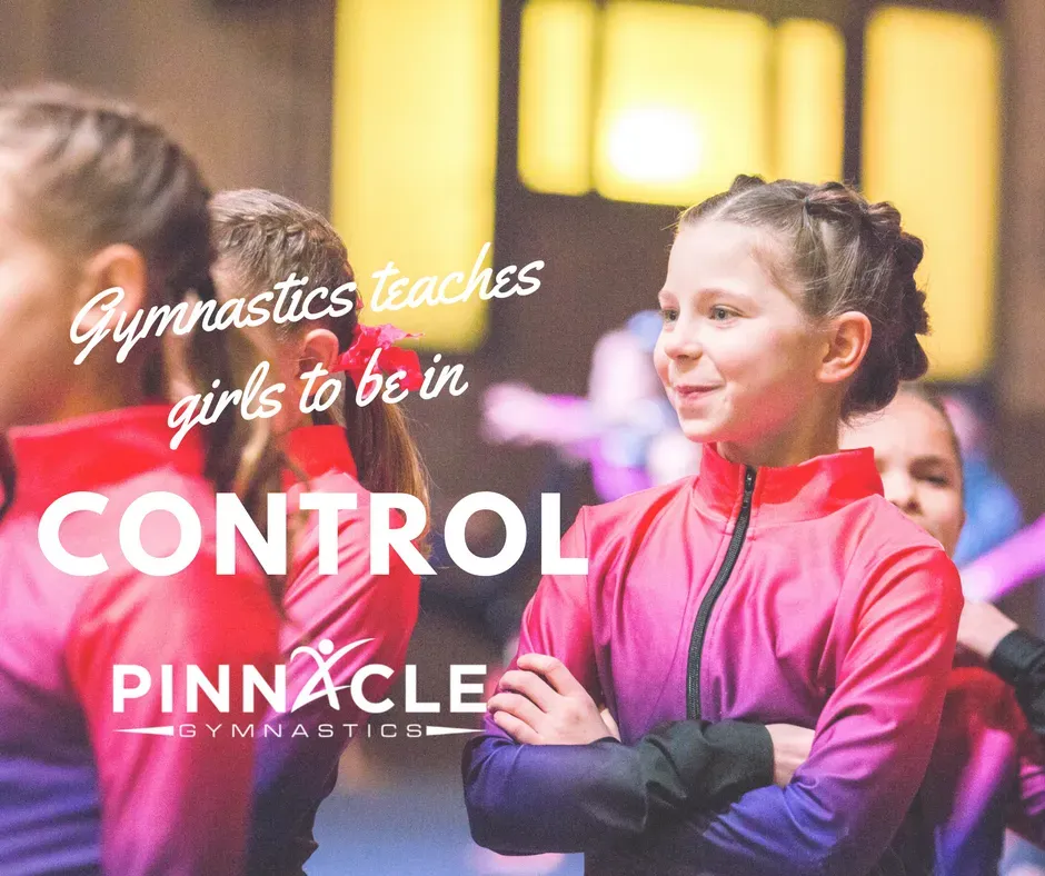 A gymnast preparing for competition confidently smiling at her teammates.