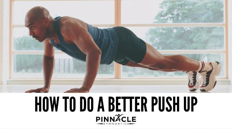 A man is doing push ups in a gym.