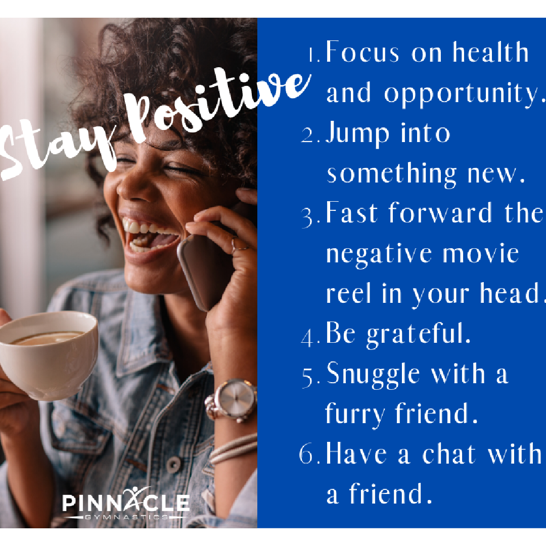 A woman engaging in a phone conversation while laughing.