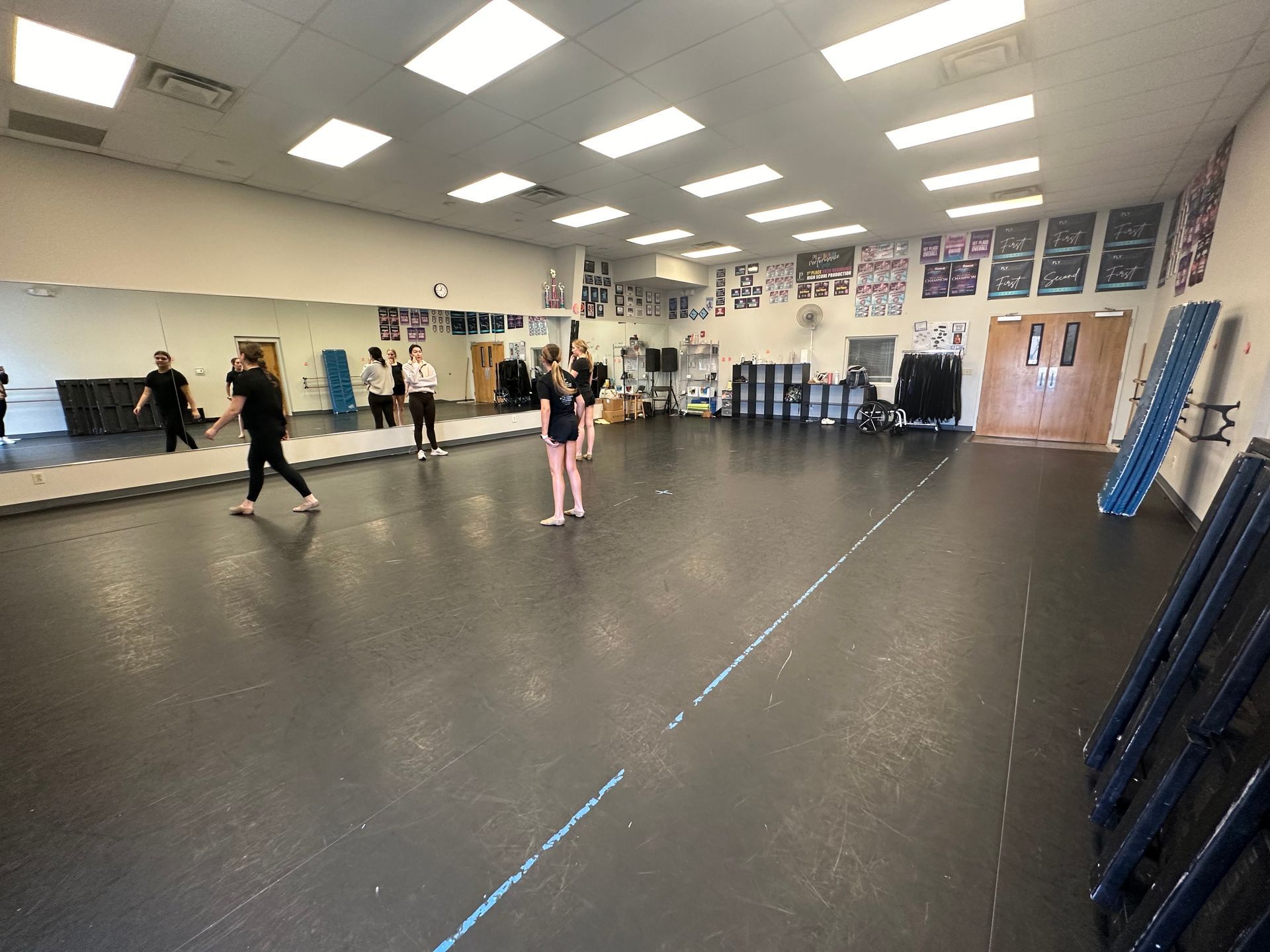 A group of people are dancing in a Pinnacle dance studio.