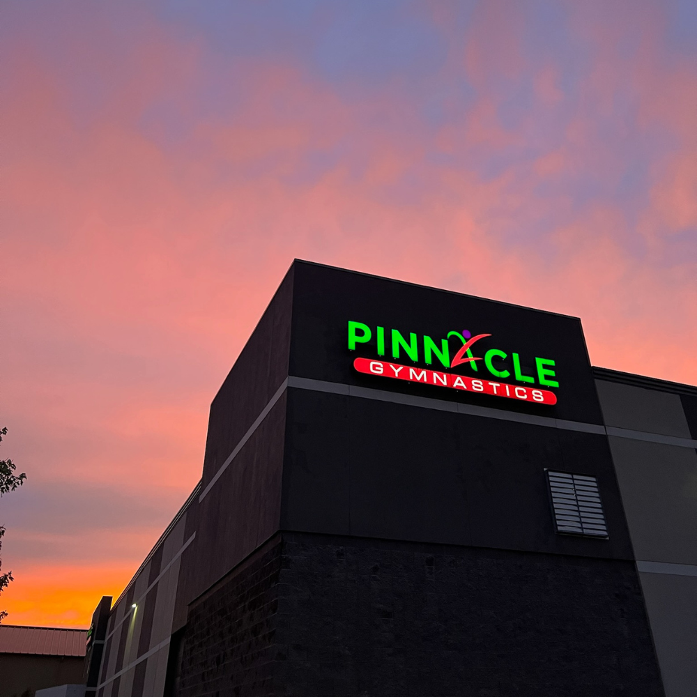 A pinnacle gymnastics building with a sunset in the background