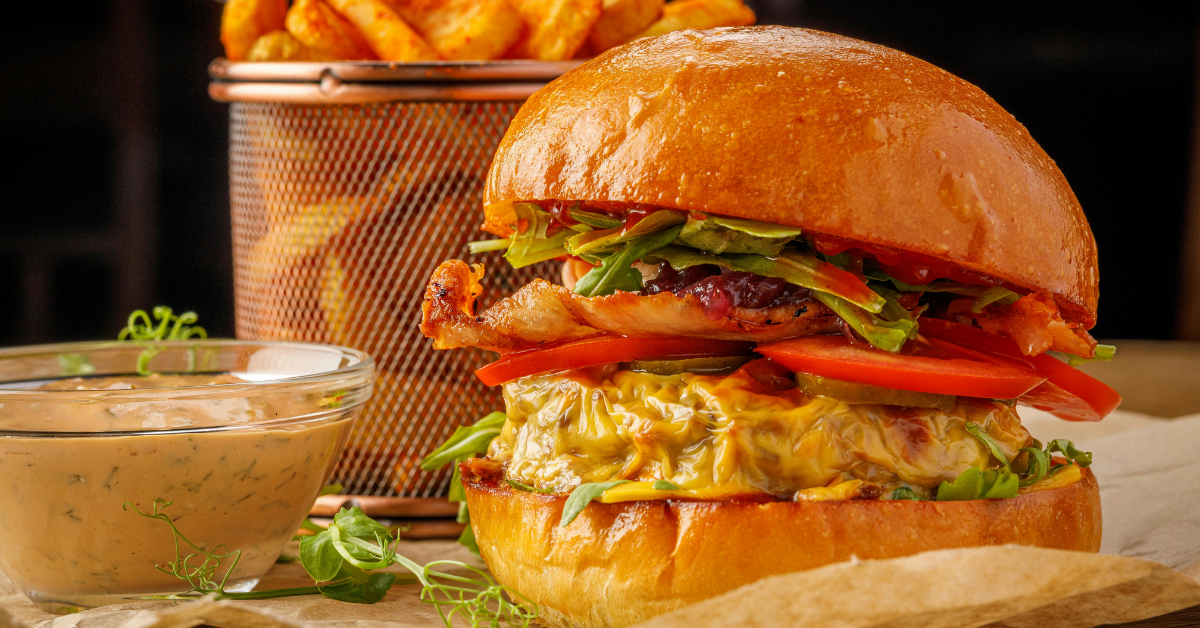 cheeseburger with bacon and fries to be enjoyed with family at the local neighborhood bar