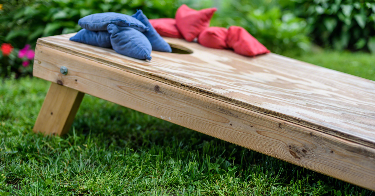 a set of bean bags on top of a cornhole board outside a restaurant