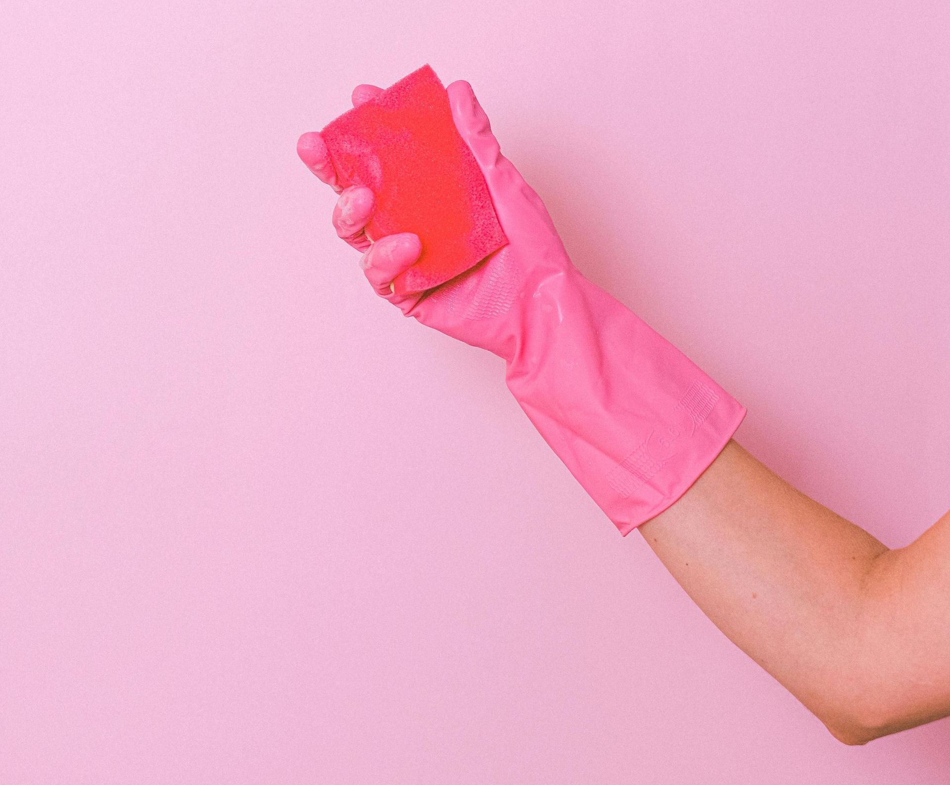 Pink sponge and pink rubber glove ready to do chores