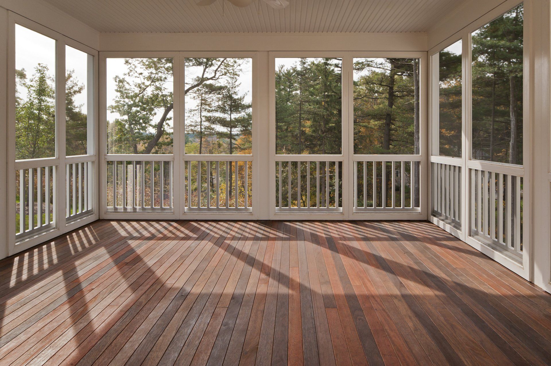 Screen Porches — Screened-In Porch with Empty Chair in Clayton, NC Screen Porches — Screened-In Porch with Empty Chair in Clayton, NC