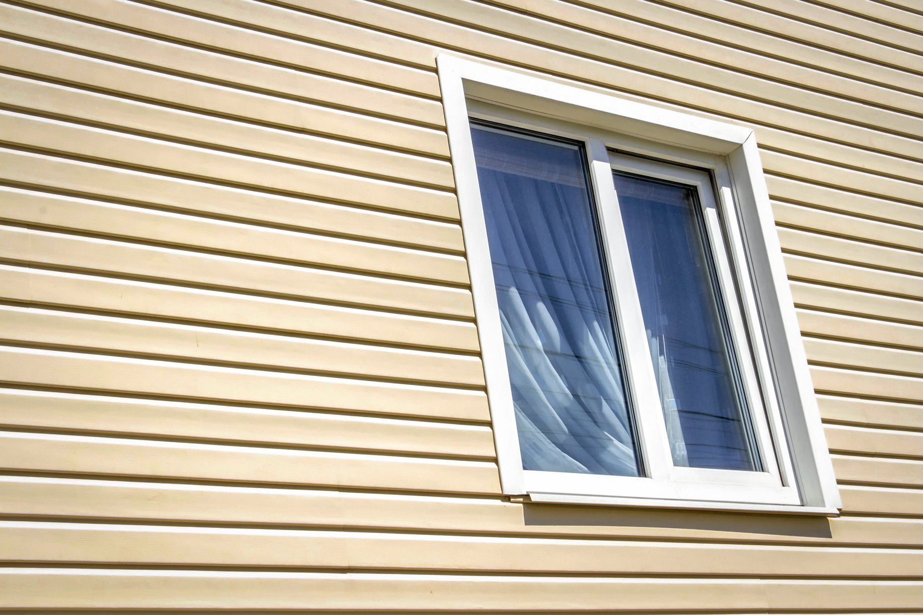 Vinyl Siding — Beige Siding with Window in Clayton, NC Vinyl Siding — Beige Siding with Window in Clayton, NC