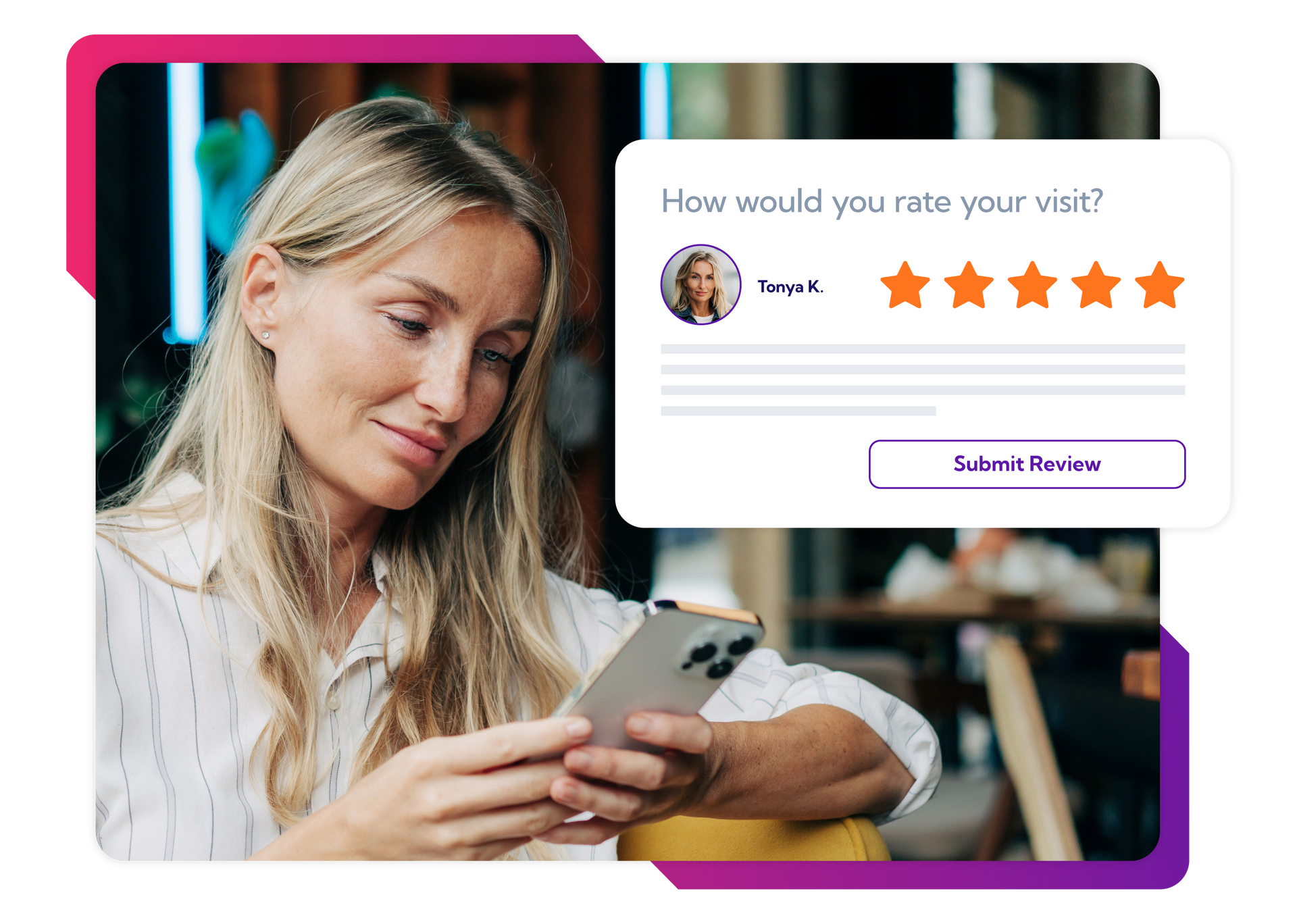 A woman is sitting at a table looking at her cell phone.