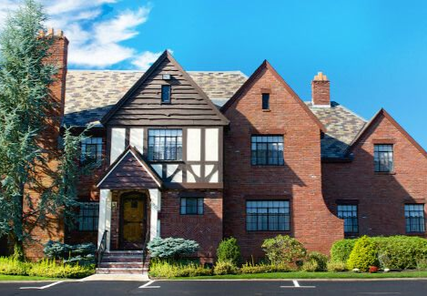 Wooden boardwalk leading to gazebo over marsh at sunrise.