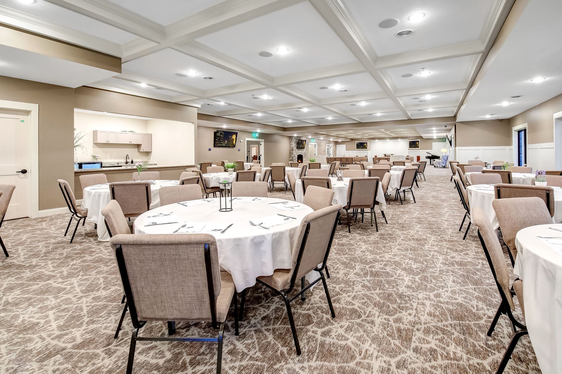 A large room with tables and chairs set up for a banquet.