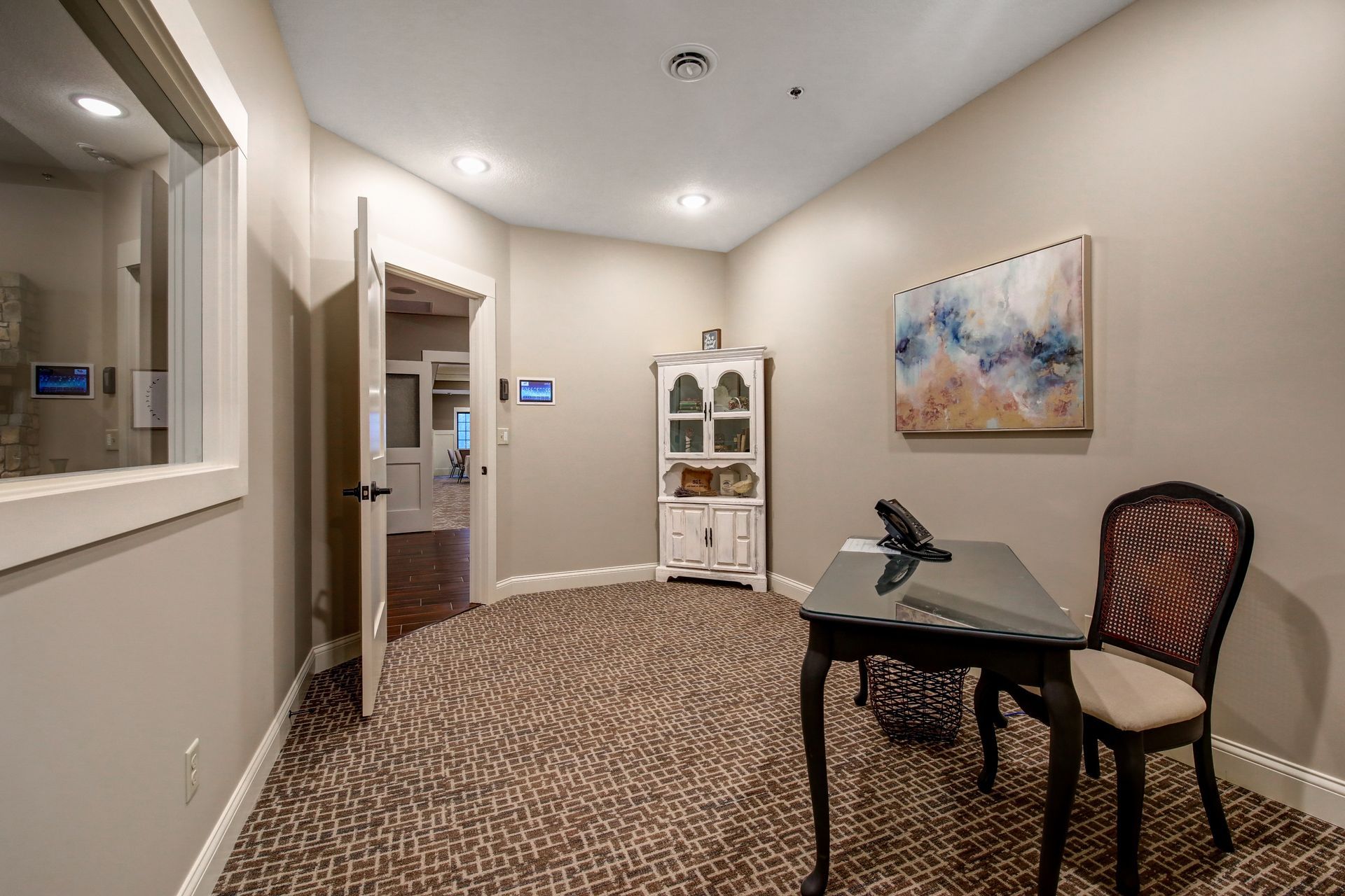 A room with a desk and chair in it.