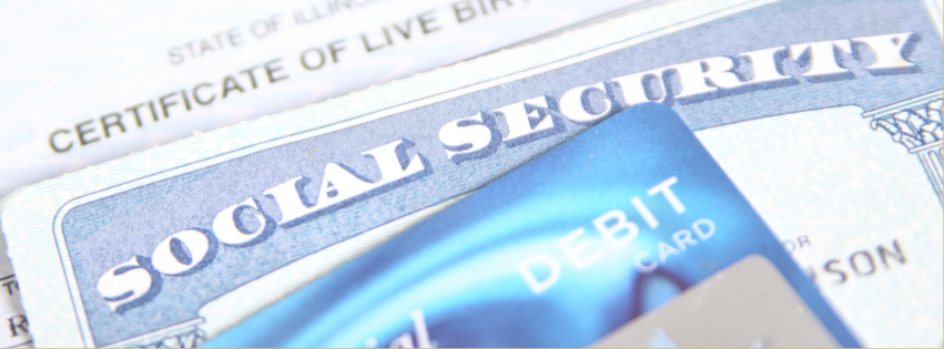 Close up of a social security card and birth certificate and credit card.