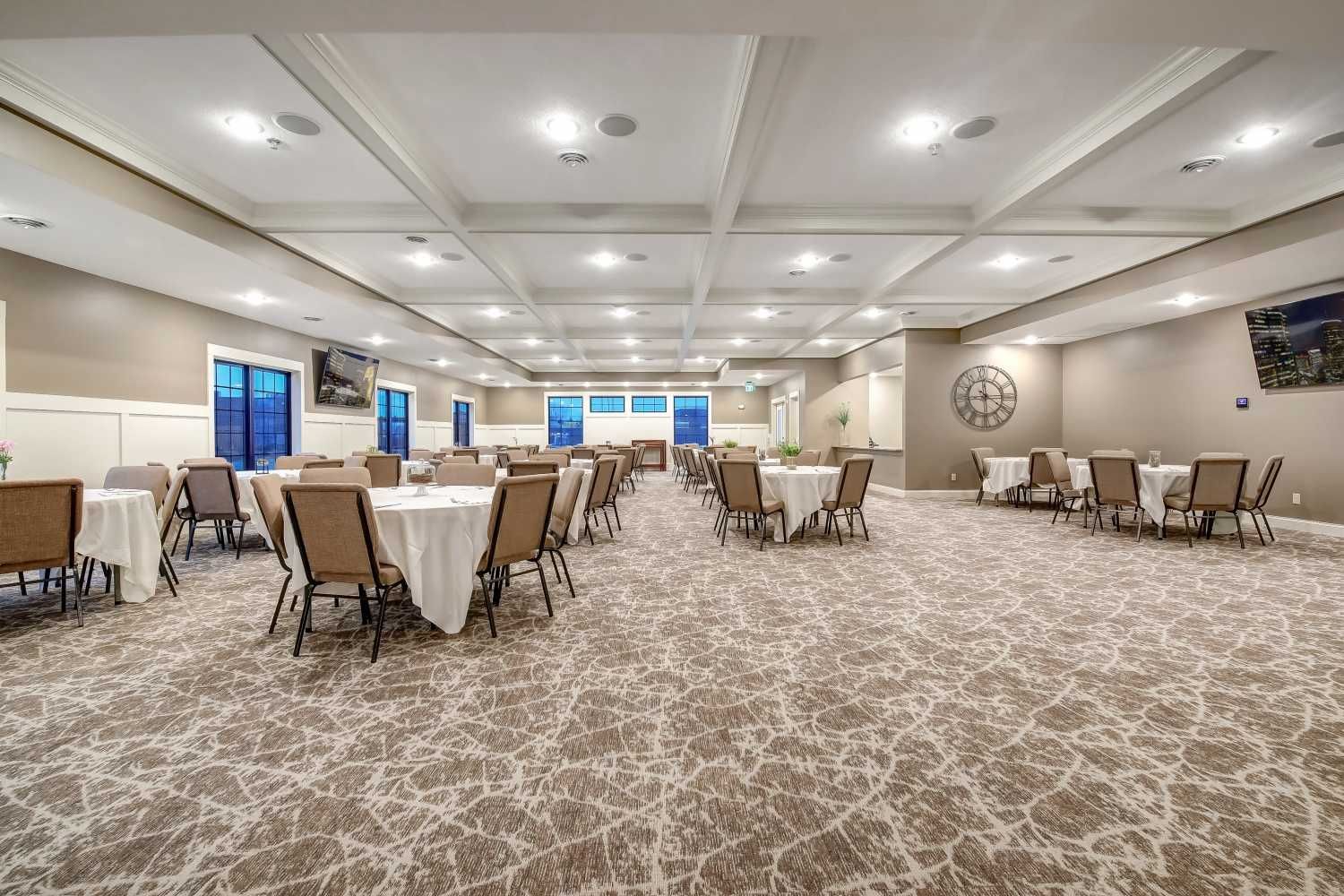 A large room with tables and chairs in it.