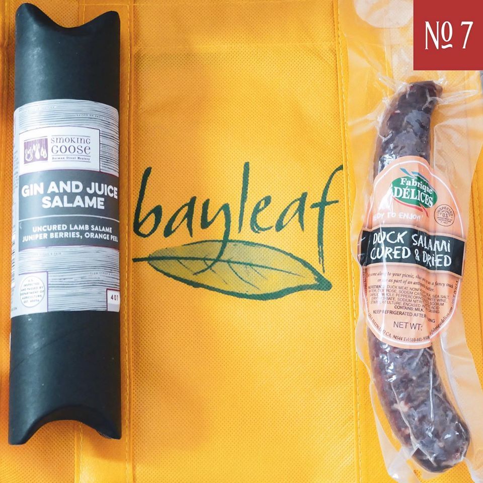 a package of bayleaf gin and juice salame and a package of wick salami