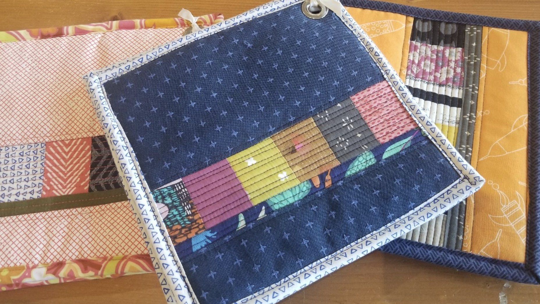 a quilted pot holder is sitting on a wooden table