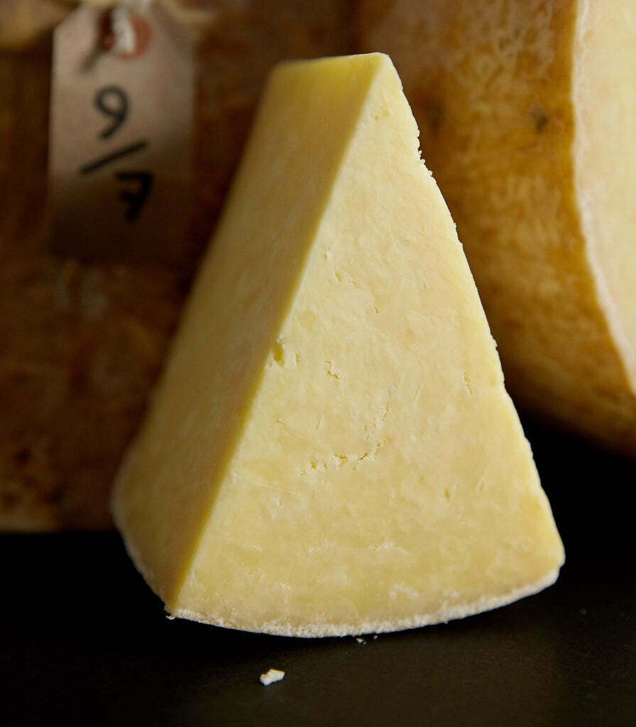 a piece of cheese with a tag that says 9/10 on it