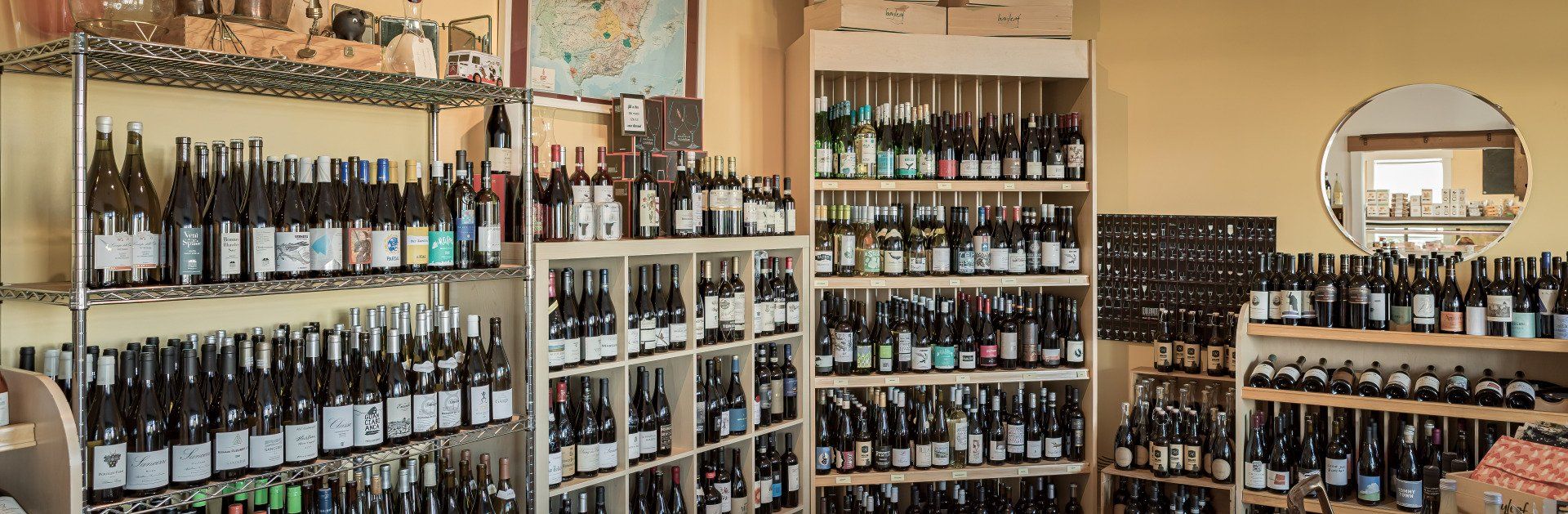 a store filled with lots of bottles of wine on shelves .