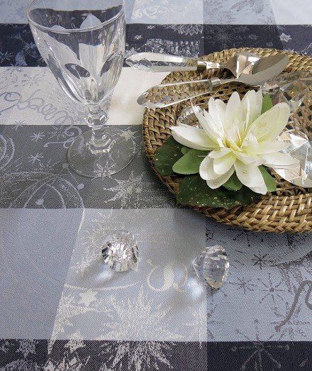 a place setting with a flower on a plate and a glass of wine