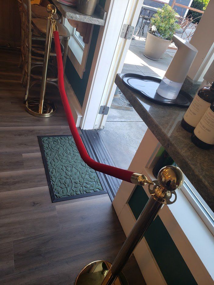 a red rope is hanging from a gold pole in a room