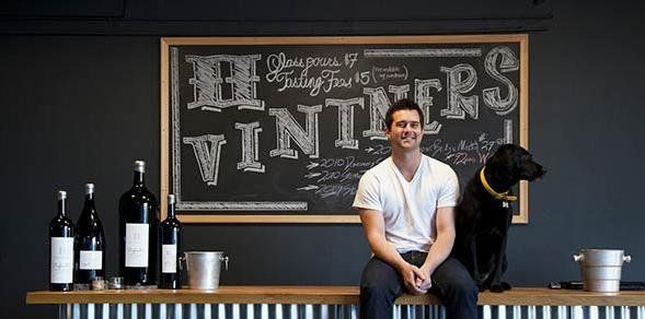 a man and his dog are sitting on a bench in front of a chalkboard that says winters .