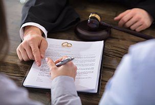 Divorce — Female Signing Contract on Desk in Courtroom in Victoria, TX