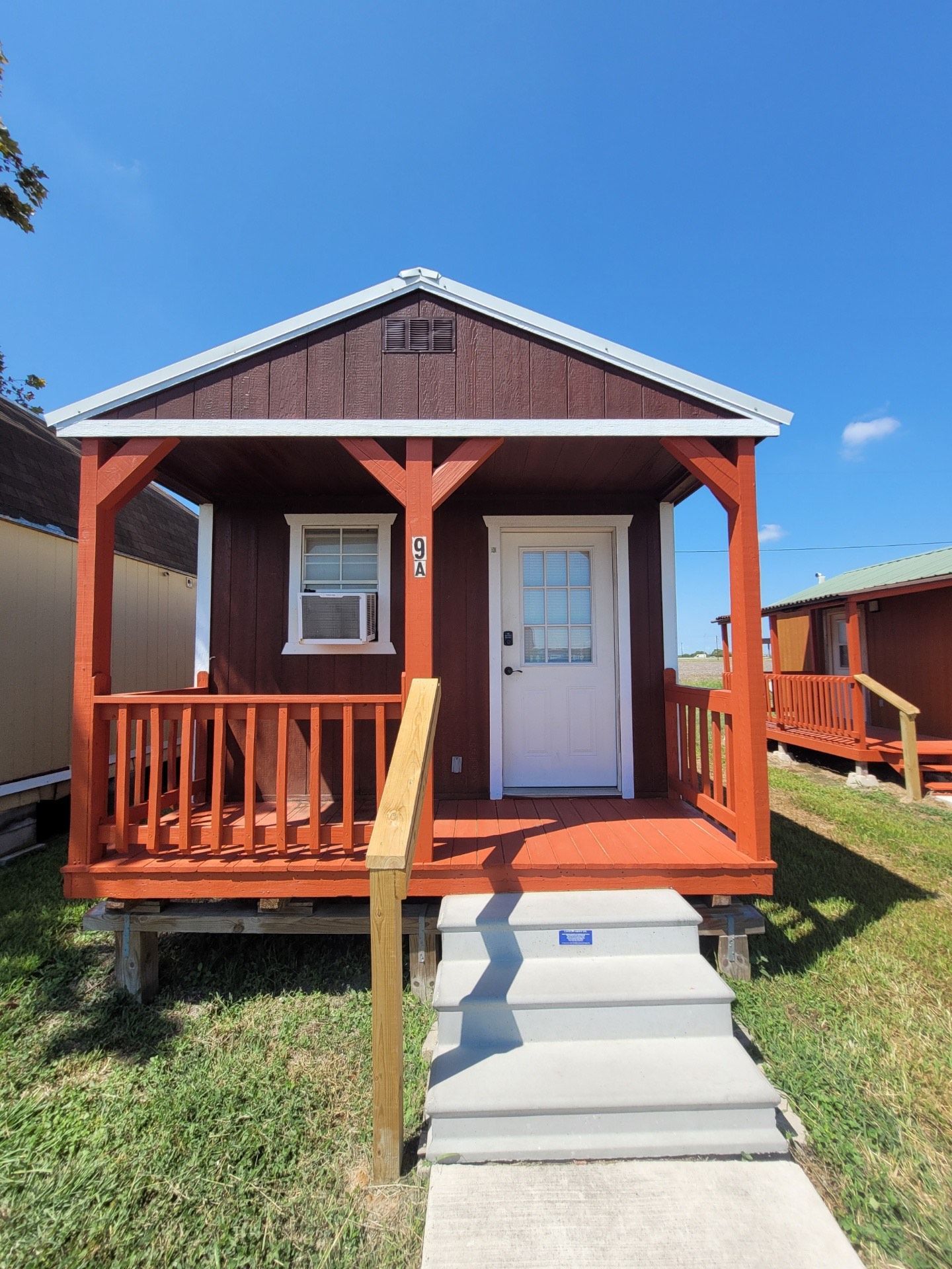 An aerial view of a rv park with a lot of rvs parked in the grass.