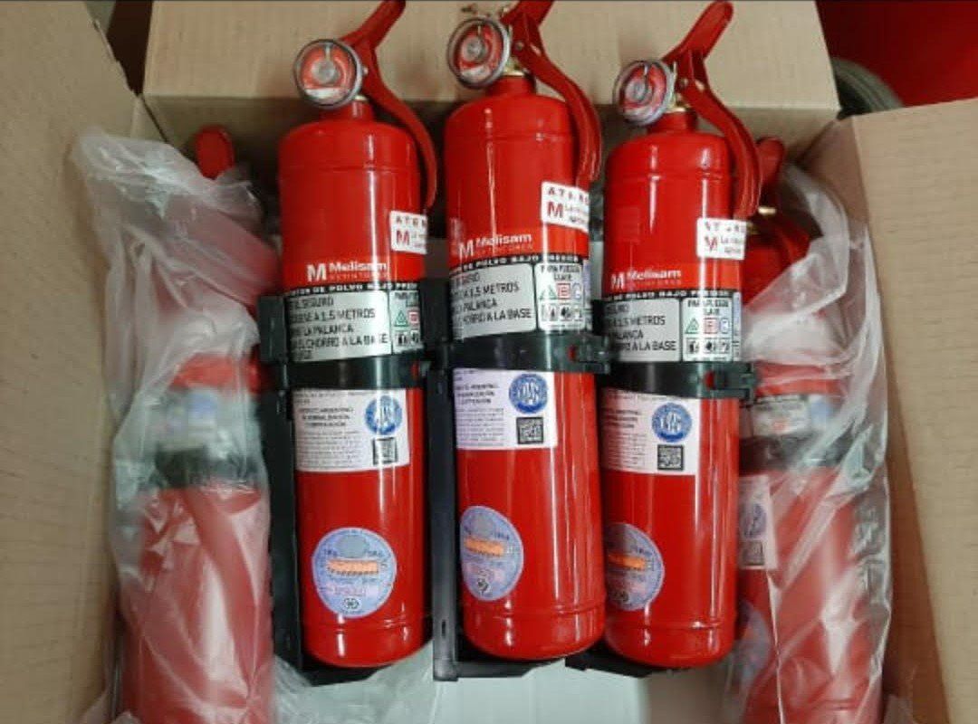 Hay tres extintores rojos en una caja.