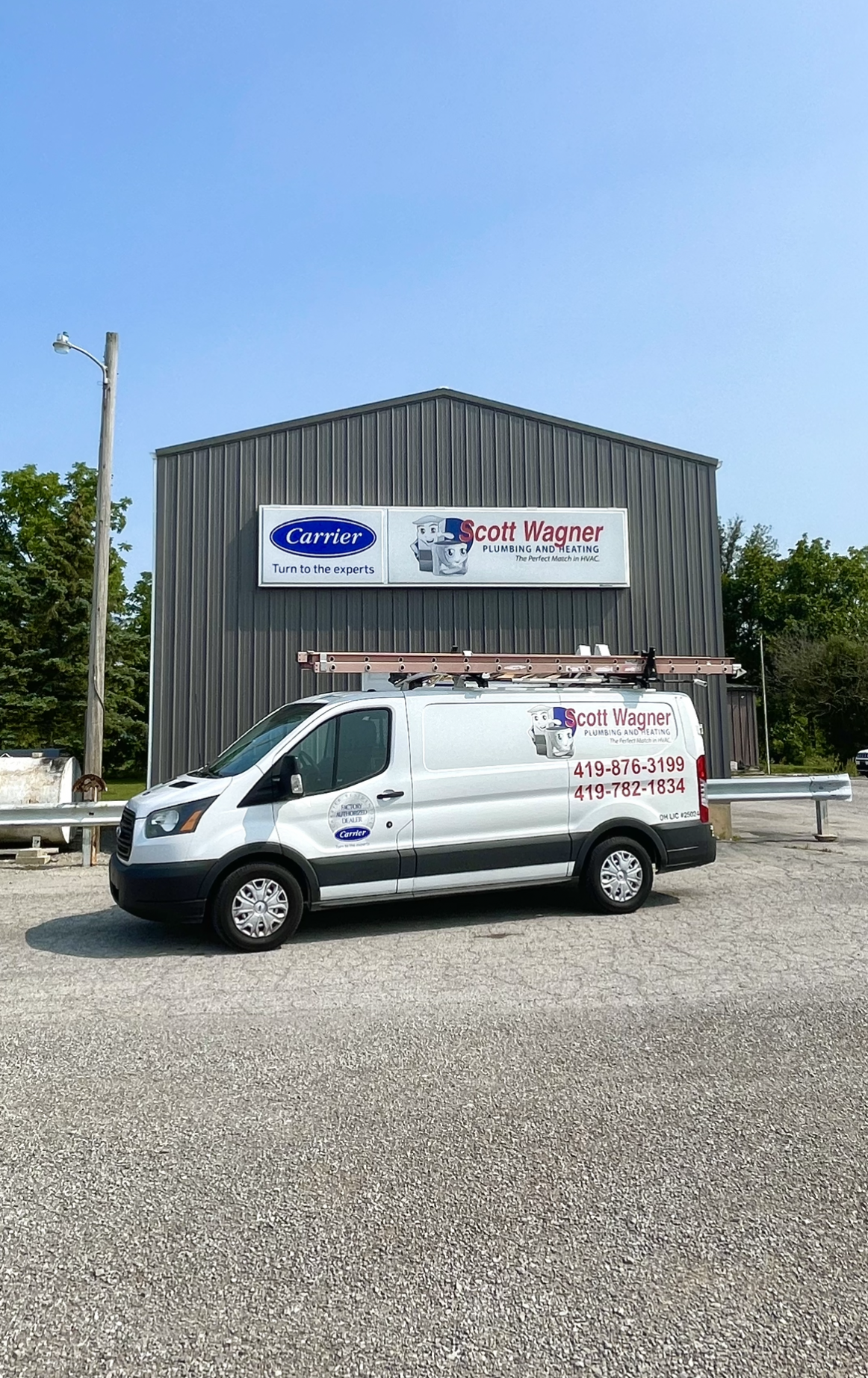 A white van is parked in front of a building.