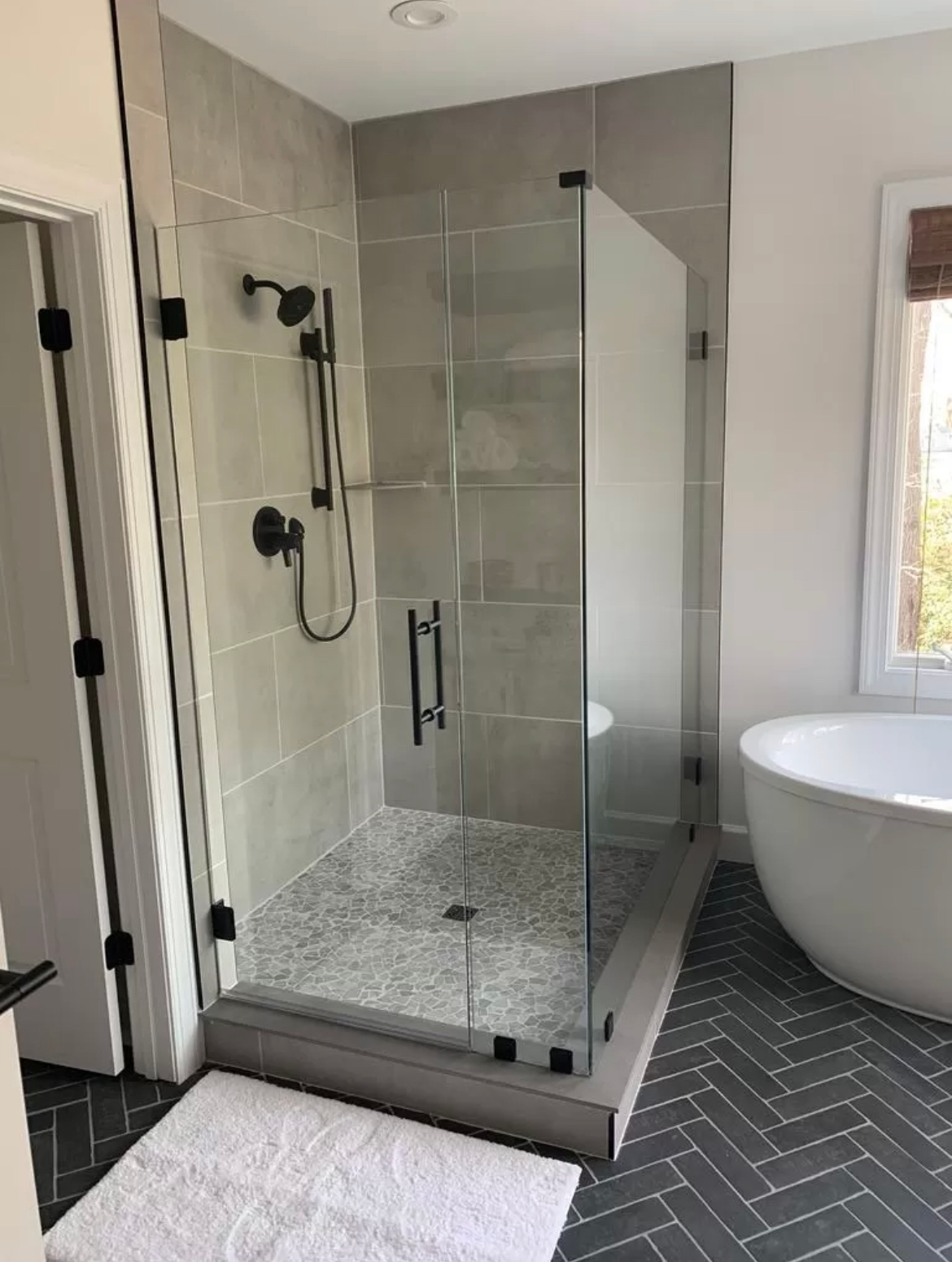 a bathroom with a walk in shower and a bathtub .