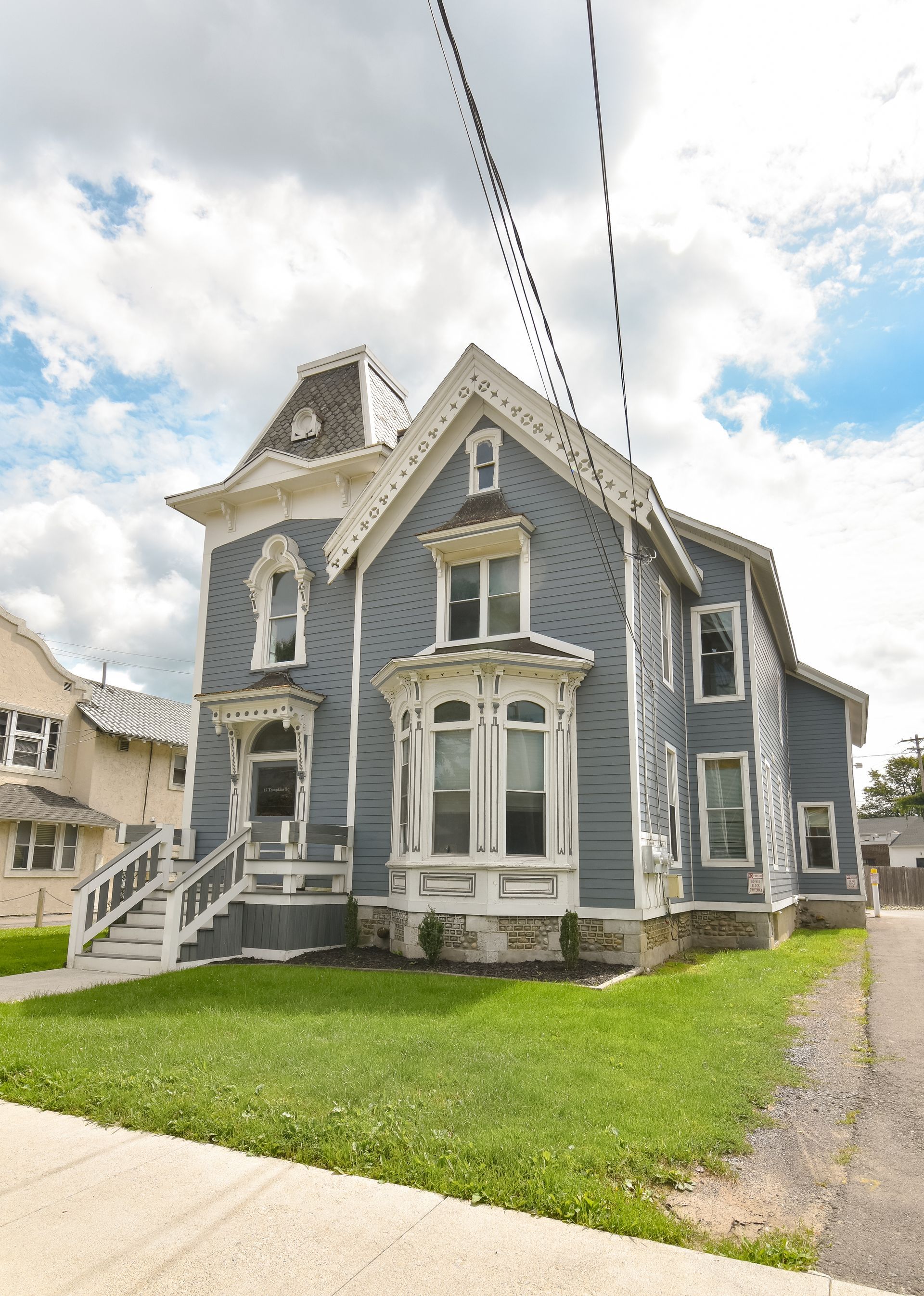 17 Tompkins  – Ornate blue Victorian-style house with decorative trim and large front windows.