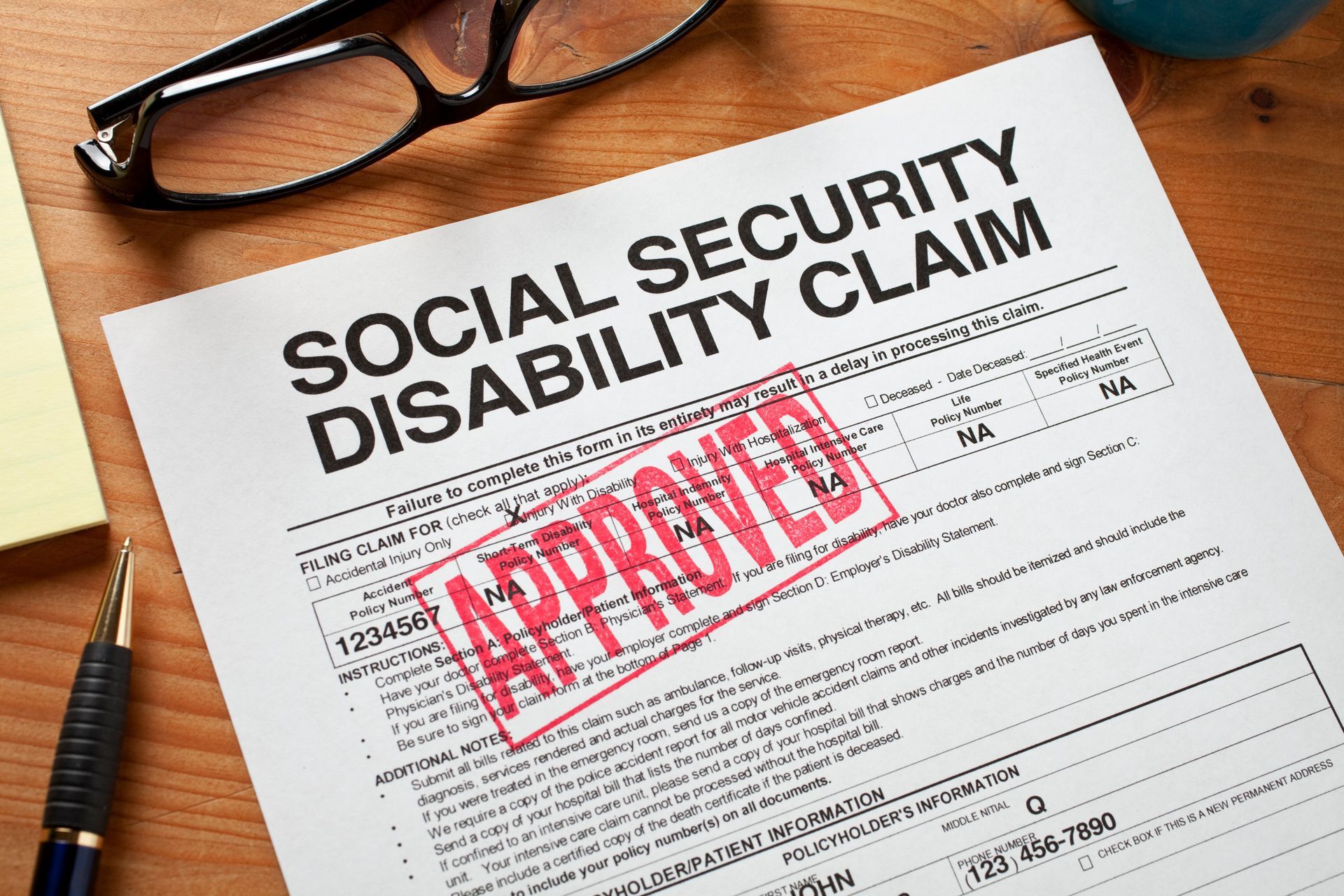 Approved Social Security Disability Claim Form on a desktop.