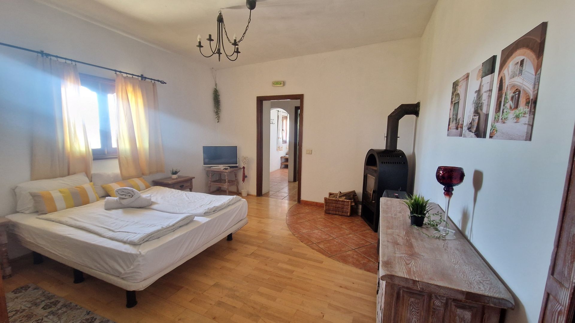 A bedroom with a large bed and a fireplace.