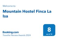 A blue sign that says mountain hostel finca la isa on it.