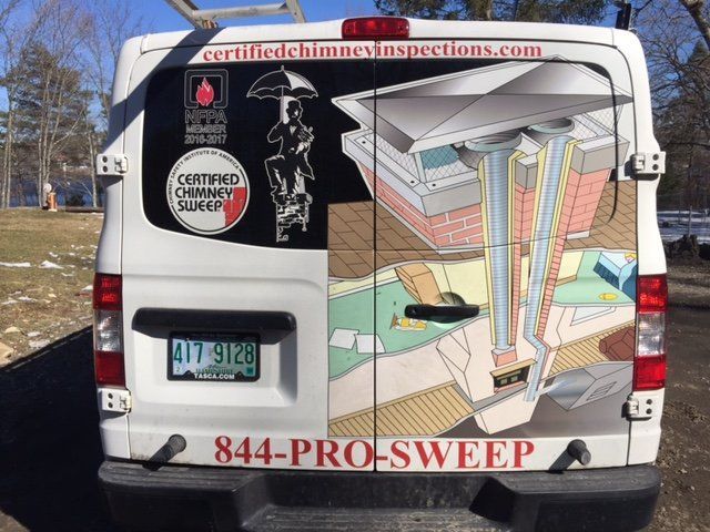 The back of a white van that says ' certified chimney sweep ' on it