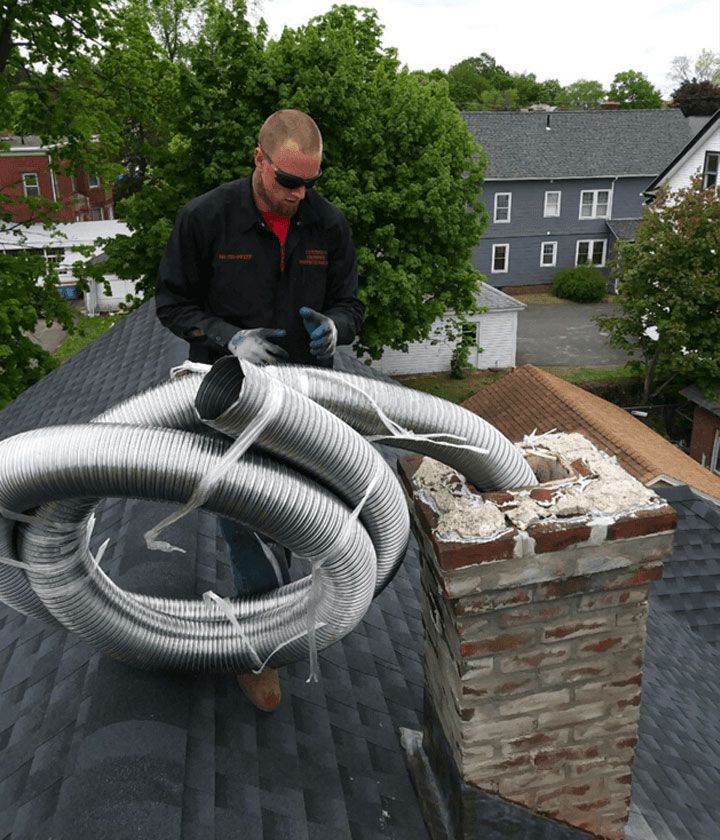 A man is working on the roof of a house