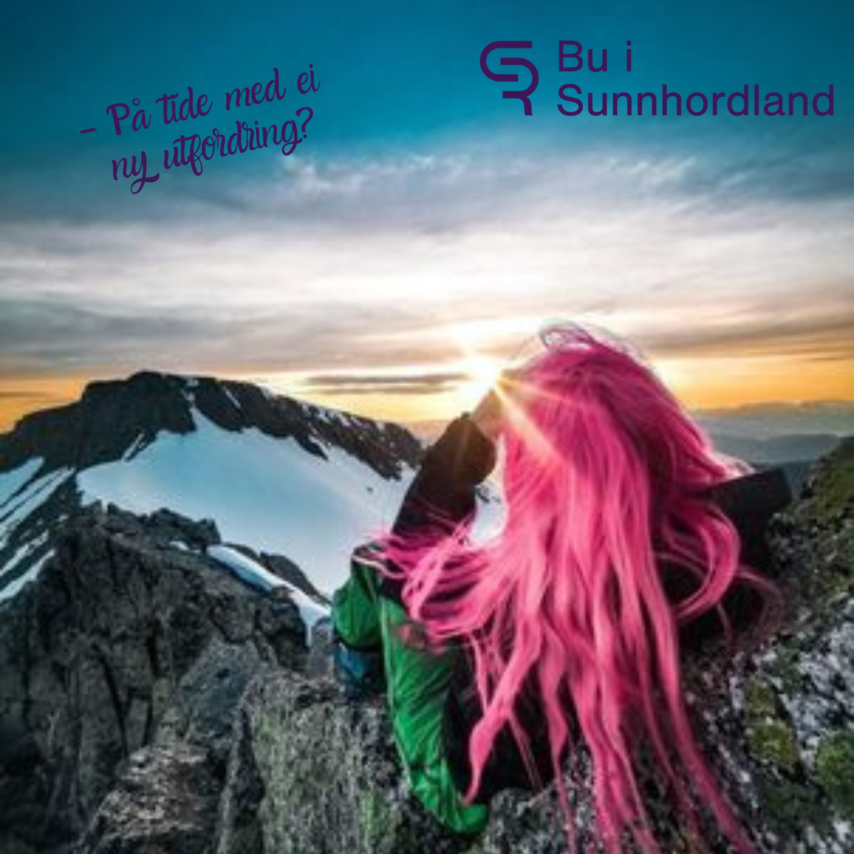 Photo of person sitting on a mountain watching the sunset and mountain tops covered in snow.