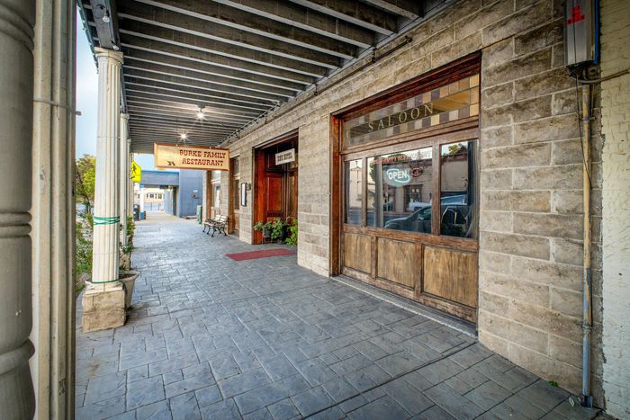 A brick building with a covered walkway leading to it.