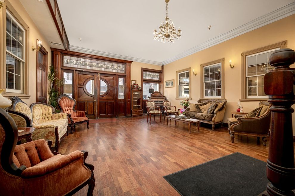 A large lobby with a lot of furniture and a chandelier.
