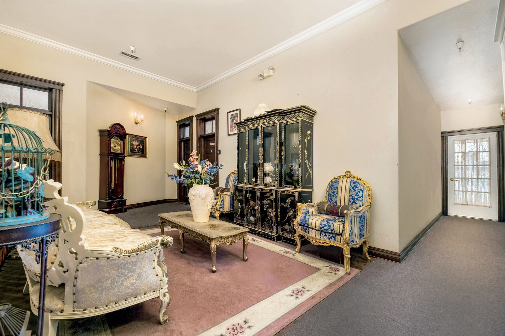 A living room with furniture and a clock on the wall.