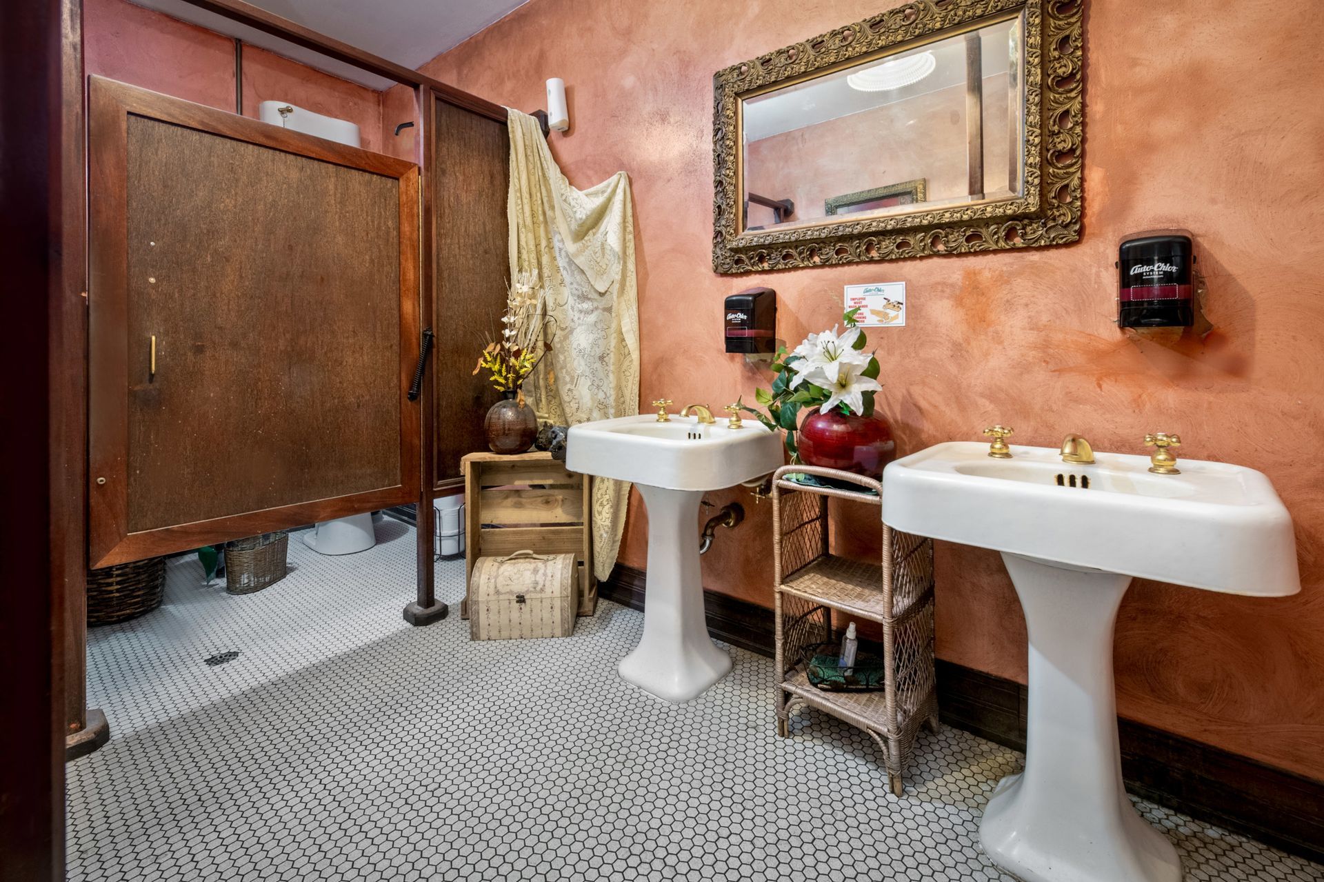 A bathroom with two sinks and a mirror on the wall.