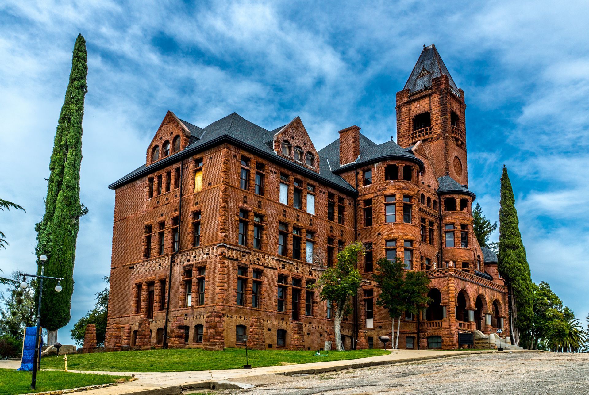 A large red brick building with a tower on top of it.