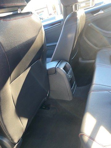 The back seat of a car with a center console